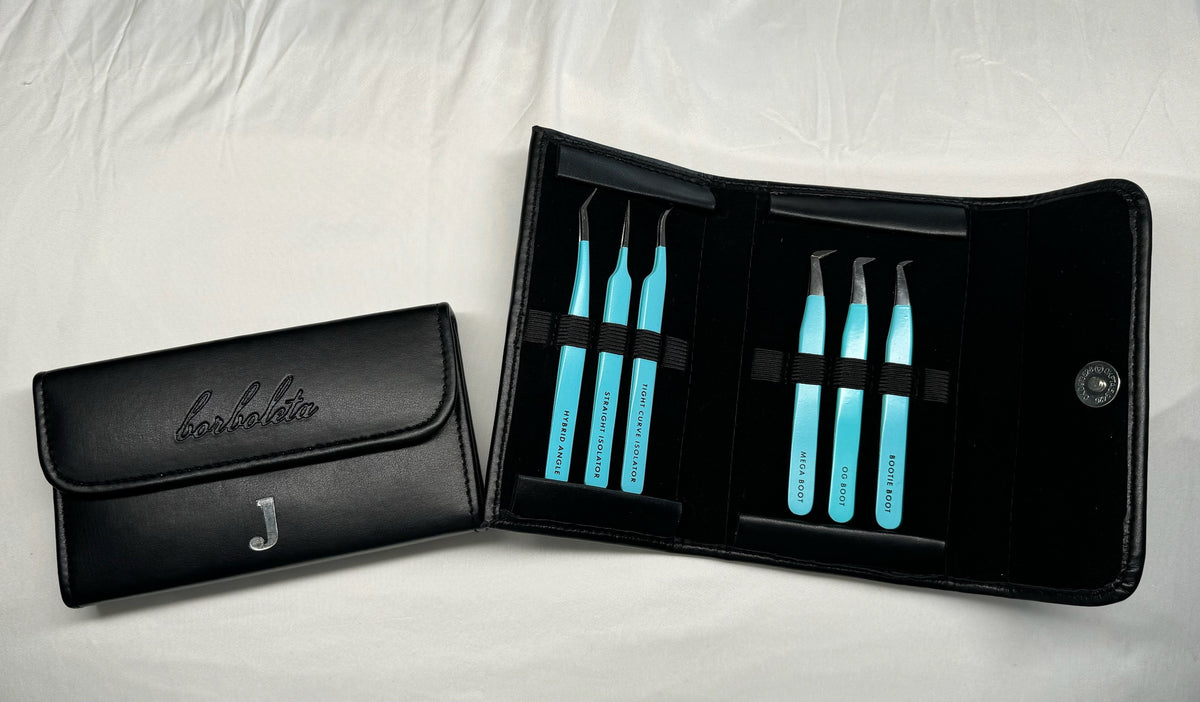 Turquoise lash tweezers arranged in black tool cases