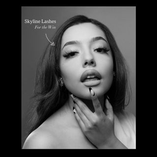 Black and white advertisement for Skyline Lashes with a model wearing false eyelashes.